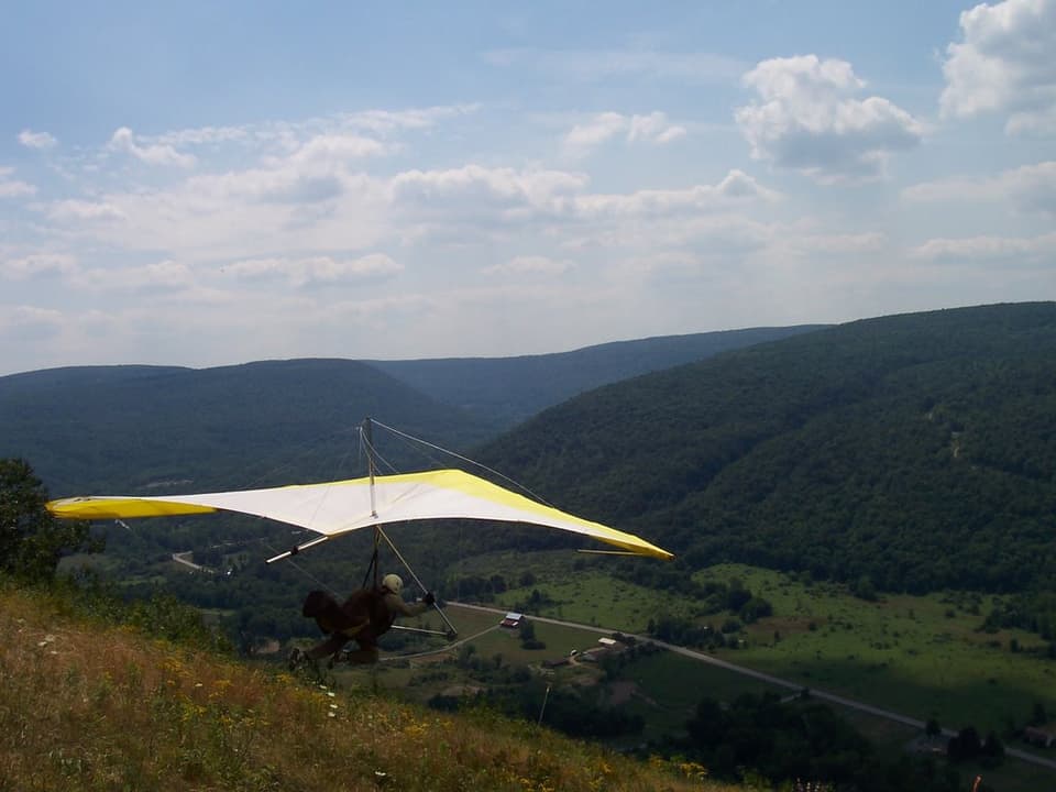 A hang glider launching into the open Bristol valley